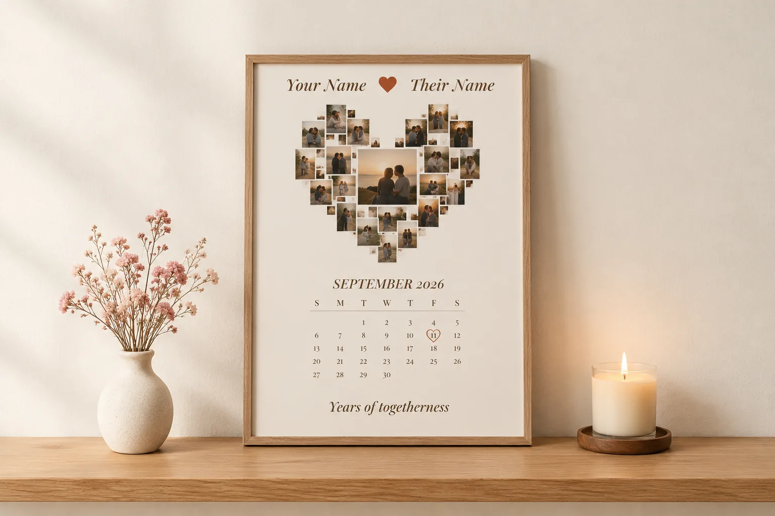 A framed poster with small photographs arranged in a heart shape above a calendar, leaning on a shelf
