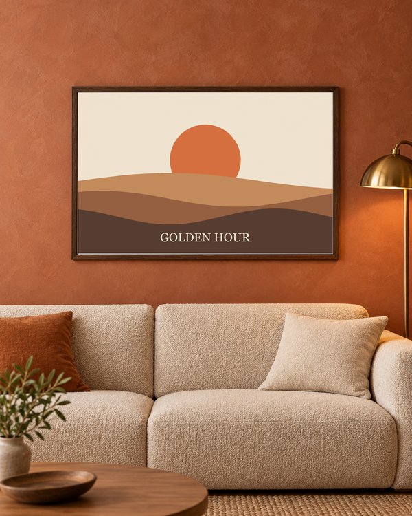A landscape walnut frame on a terracotta wall above a beige sofa