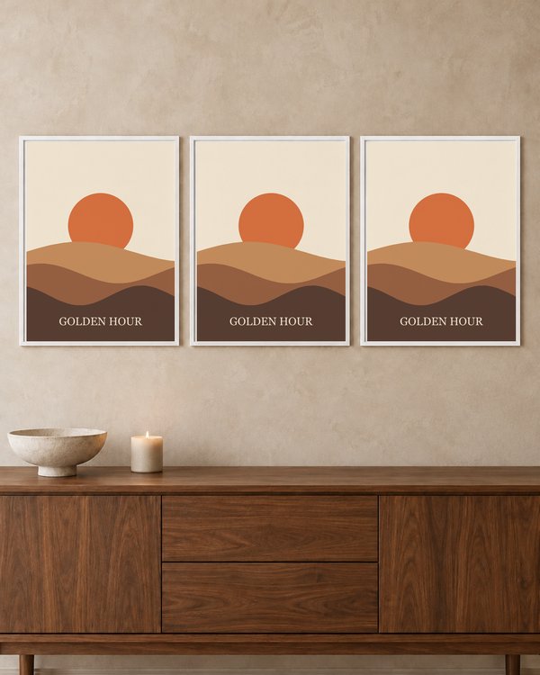 Three white frames in a row on a beige wall above a walnut sideboard